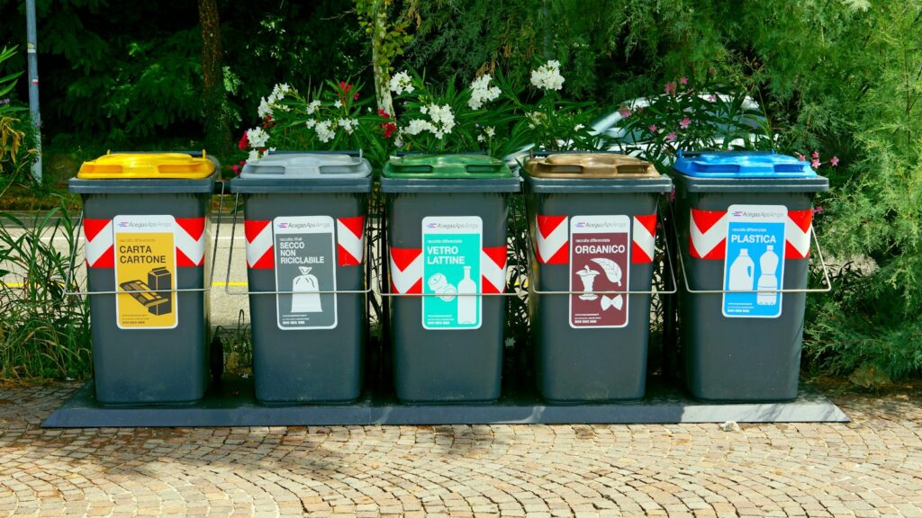 a row of trash cans sitting on top of a sidewalk - free up disk space in Windows using the Recycle Bin
